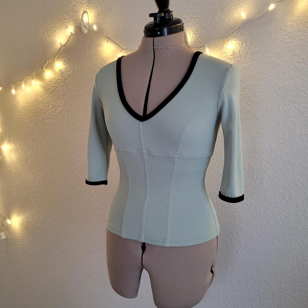 bebe Women's Top in Soft Green with Black Accents